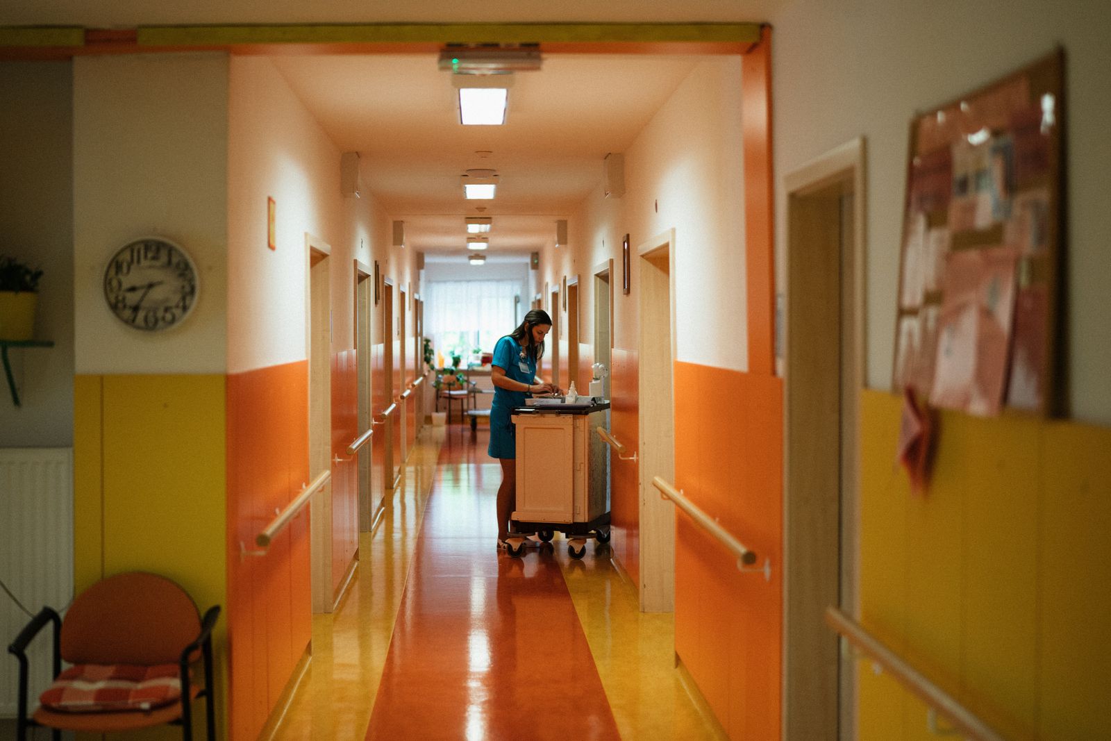 Hospital corridor with a nurse at work