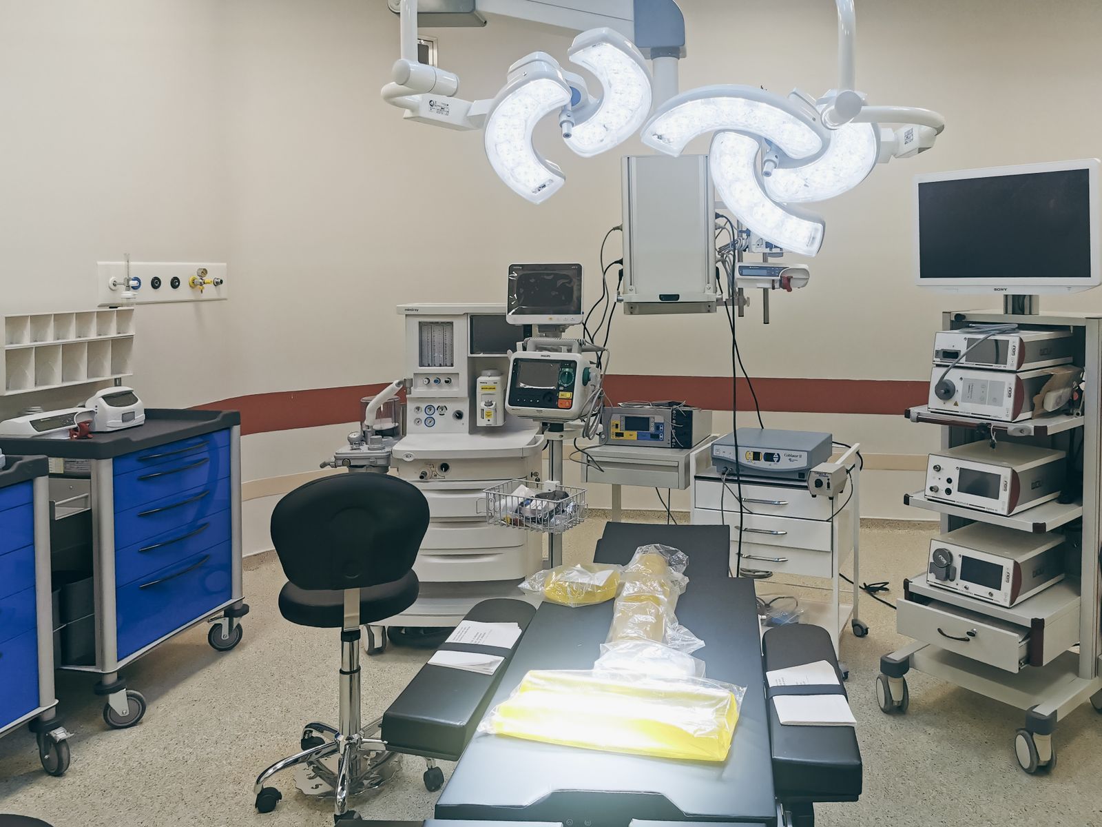 Hospital operating room with surgical lights and equipment carts
